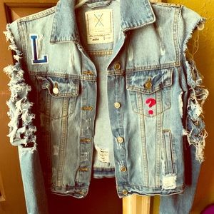 Distressed and patched denim jacket